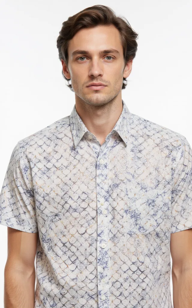 A French model wearing a Scale pattern   printed shirt, against a white background, in a front   facing bust portrait